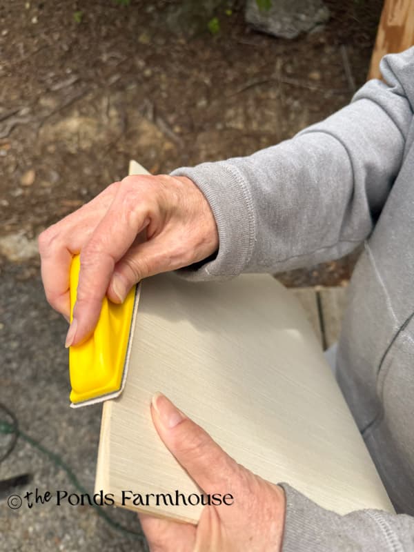 Sand edges of fake drawer fronts until smooth with hand sander