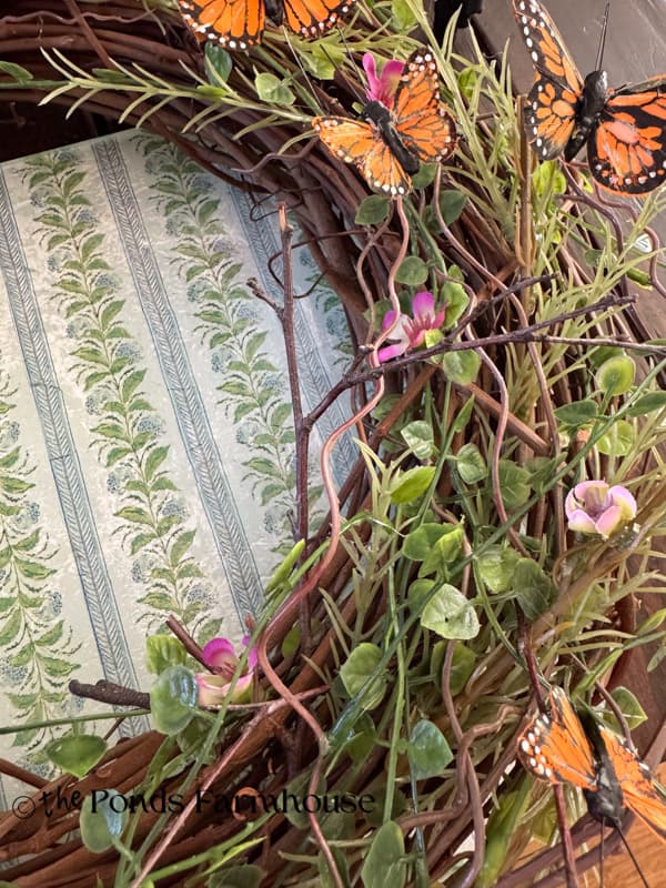 Small Flower buds are added to less dense side of wreath