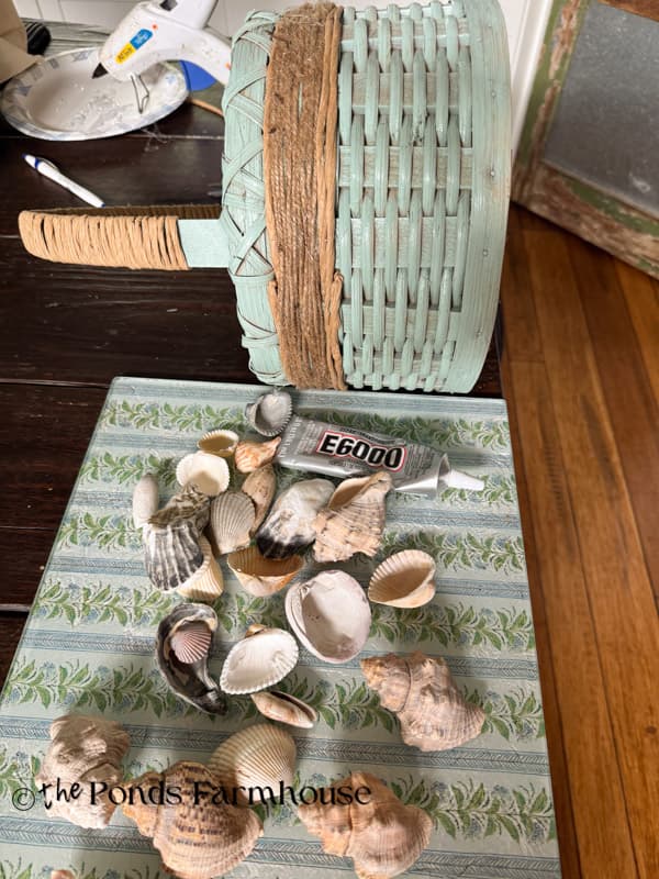 seashells and glue to adhere to the thrifted basket