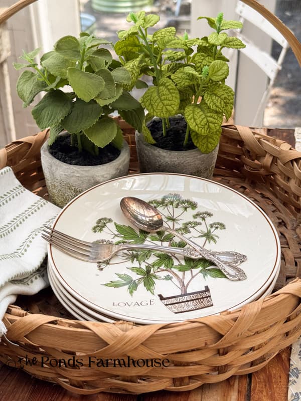 vintage basket with extra plates and napkins with herbs 