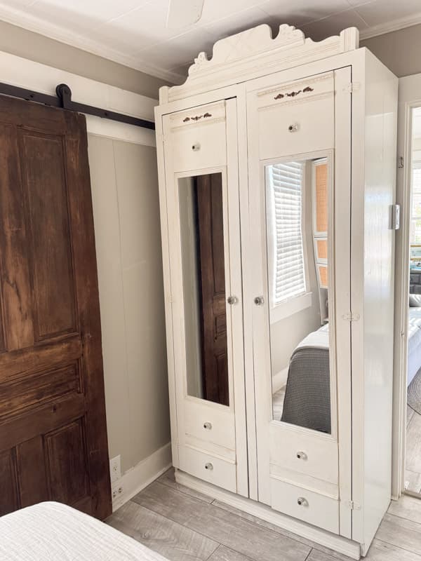 DIY antique armoire in tiny beach cottage bedroom