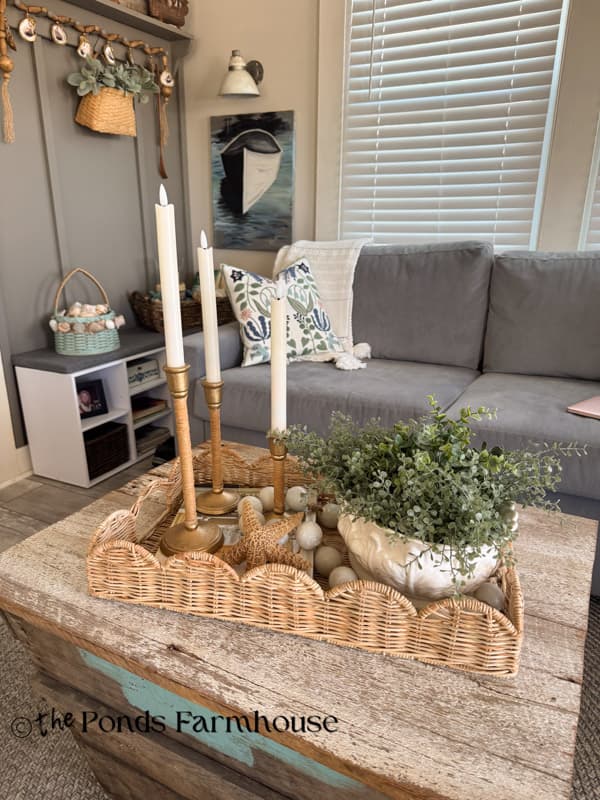 DIY rattan & brass candlestick holders inspired by Serena & Lily on woven tray on coffee table.