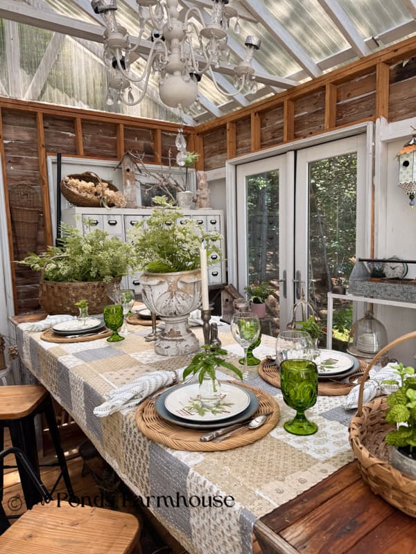 Long view of summer tablescape with thrifted botanical dishes and wild flowers.  