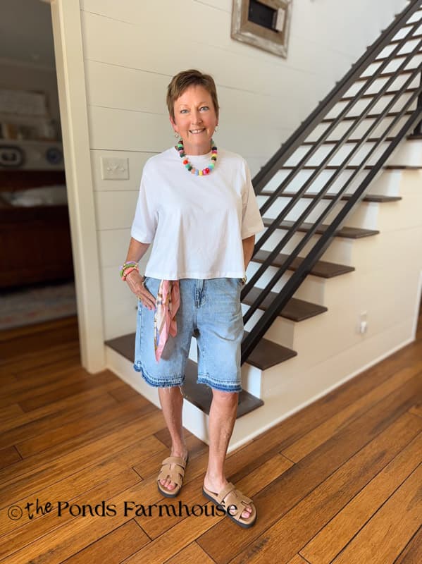 Rachel in denim jorts and trapize white tee with beaded necklace