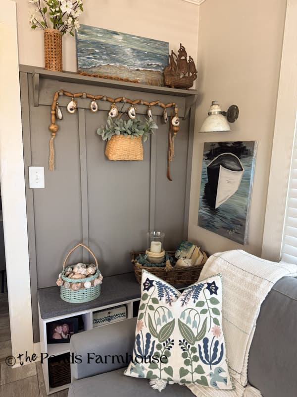 Accent wall with oyster shell garland & beach painting