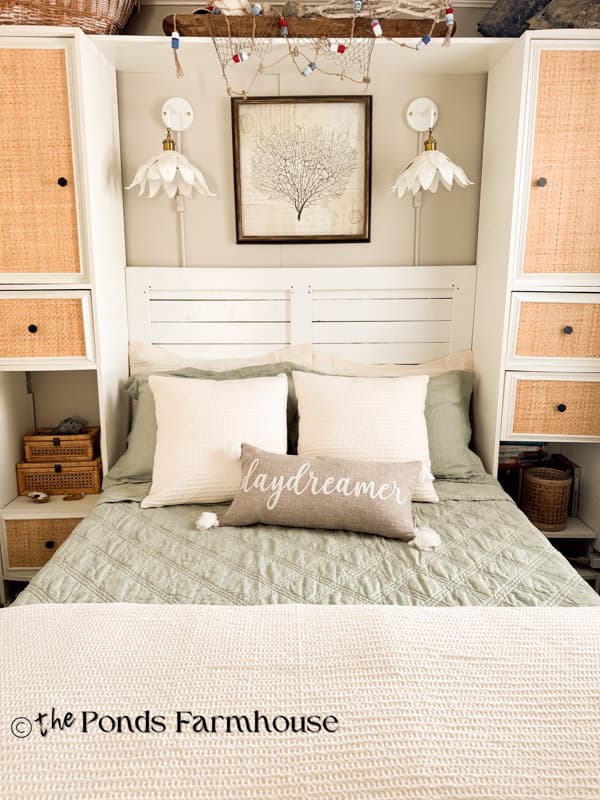 Beach cottage bedding with DIY rattan cabinets and wall sconces