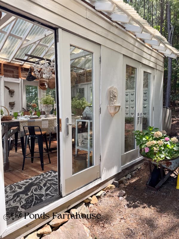 Welcome to the greenhouse outdoor view with summer table