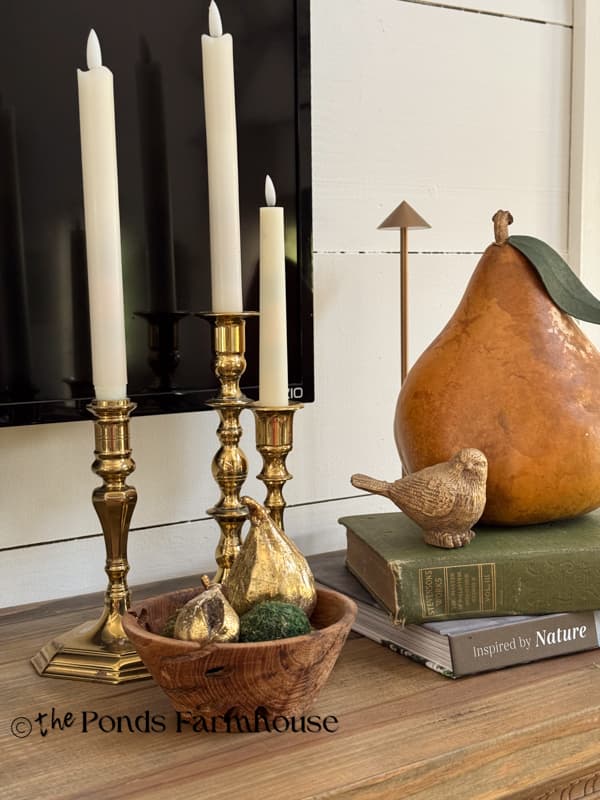 Candlesticks with gold accent decor and gourd apple.