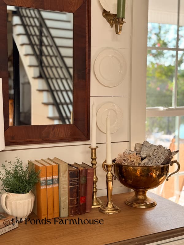 Entry Table Decorated for late summer/Early fall with vintage books and antique brass