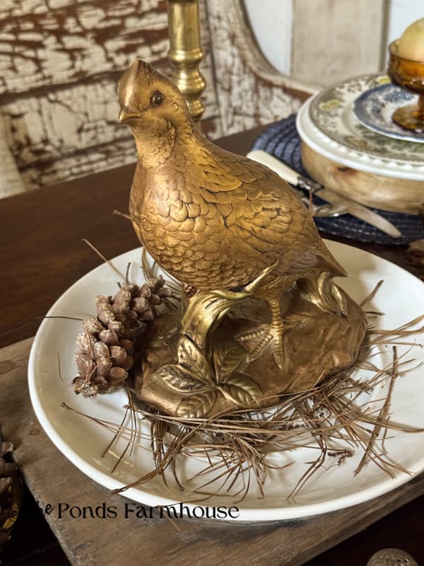 Gold pheasant on white plate for dining table centerpiece