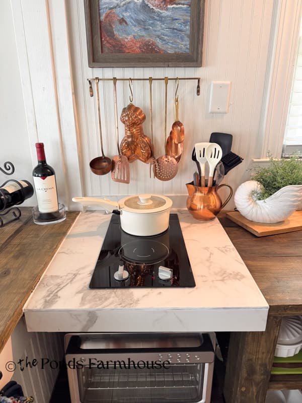 small beach cottage with space saving two burner cooktop and tile countertop