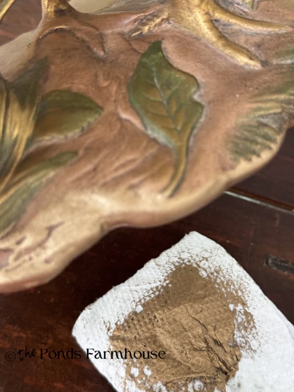 adding european gold to the base and leaves of the pheasant figurine.