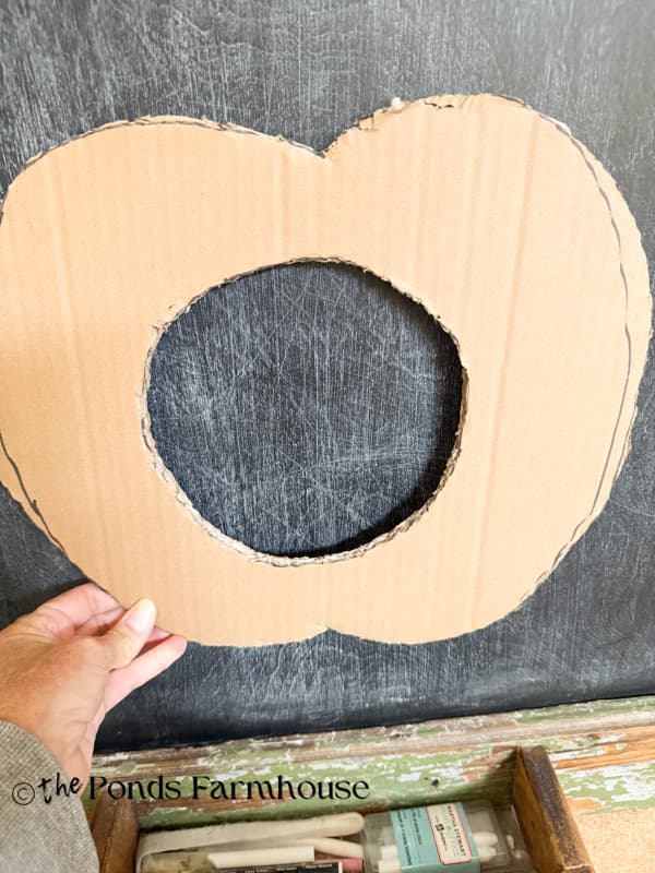 Cut the pumpkin shape out of recycled cardboard