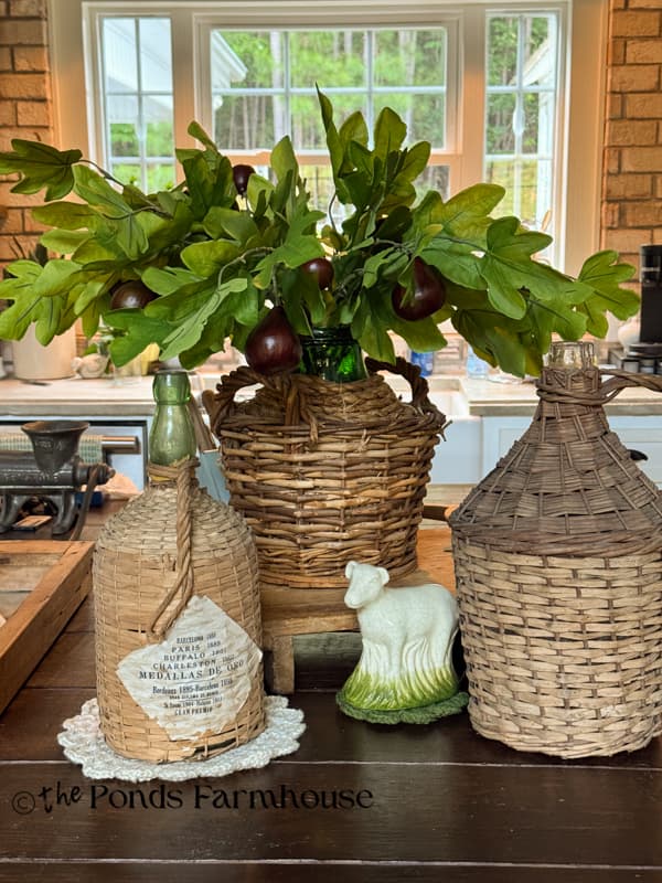 early fall kitchen island with demi-johns & faux fig stems