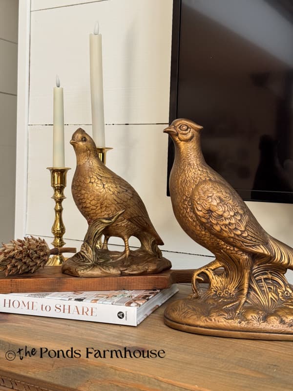 two antique gold pheasants on mantel