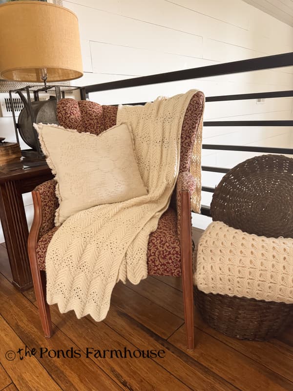 vintage crocheted throw blankets and candlewick pillow on corner chair in loft