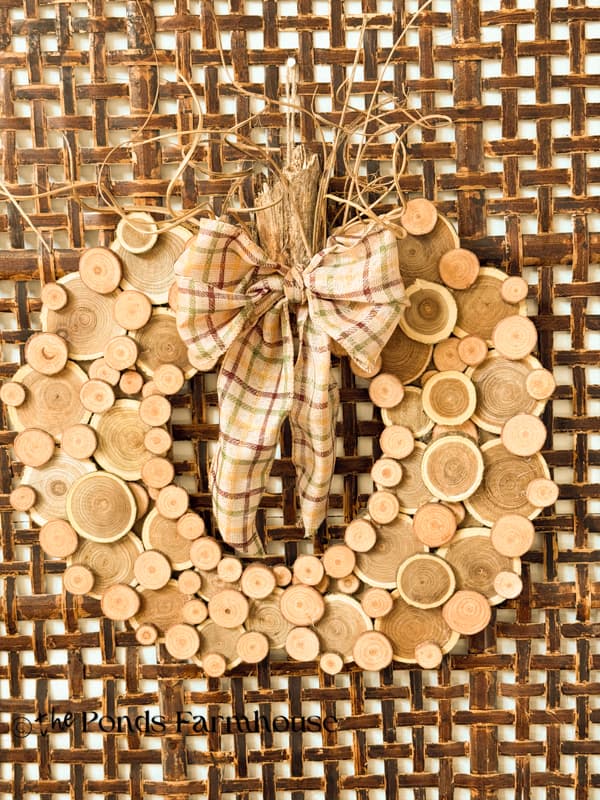 DIY Wood Slice Pumpkin Wreath on wall basket
