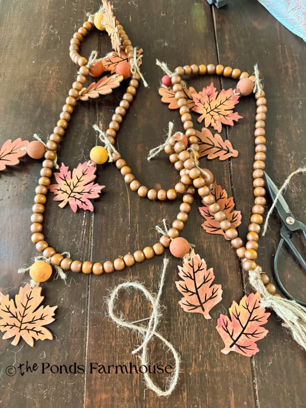 Bead garland with painted wooden leaves for mantel garland