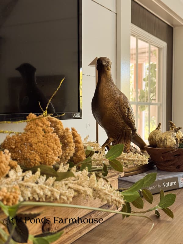 cozy fall mantel decor with pheasant and gold accents