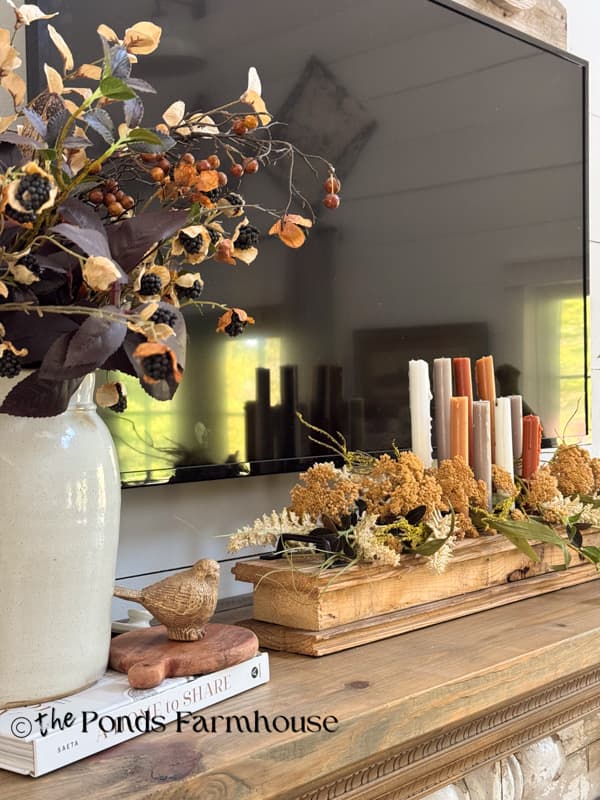 crock and DIY wooden candleholder on budget-friendly cozy fall mantel