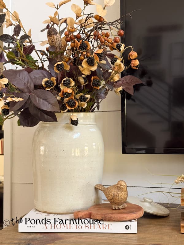 DIY vintage crock with gold bird on cozy fall mantel