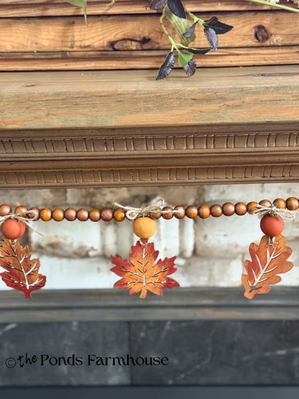 DIY Wooden Leaf Garland with Beads on Fireplace Mantel