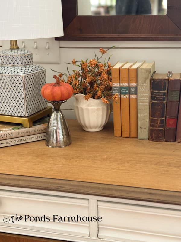 Entry Table vignette with DIY Mercury glass upcycle with a pumpkin on top.