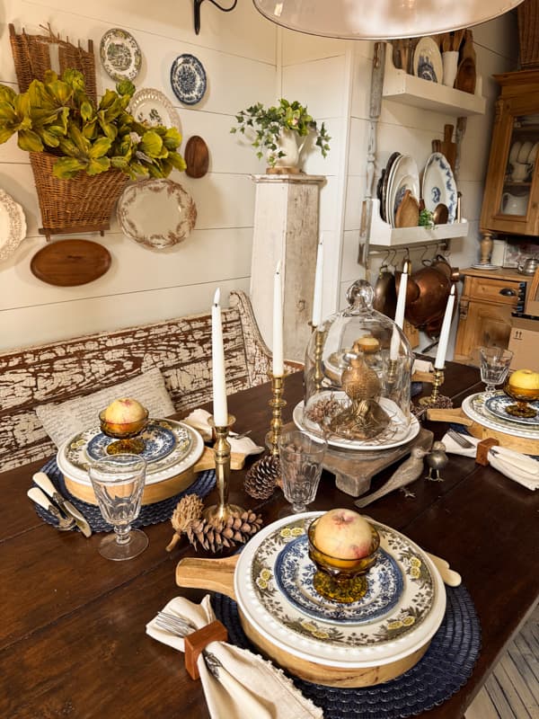 fall table with blue and brown dishes with apple at place setting