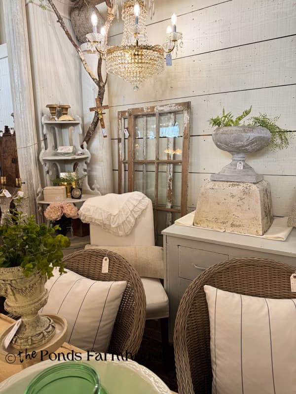 beautifully curated antqiue mall booth with architectural elements & lighting