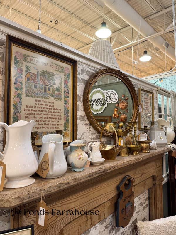 beautifully curated antqiue mall booth with mantel