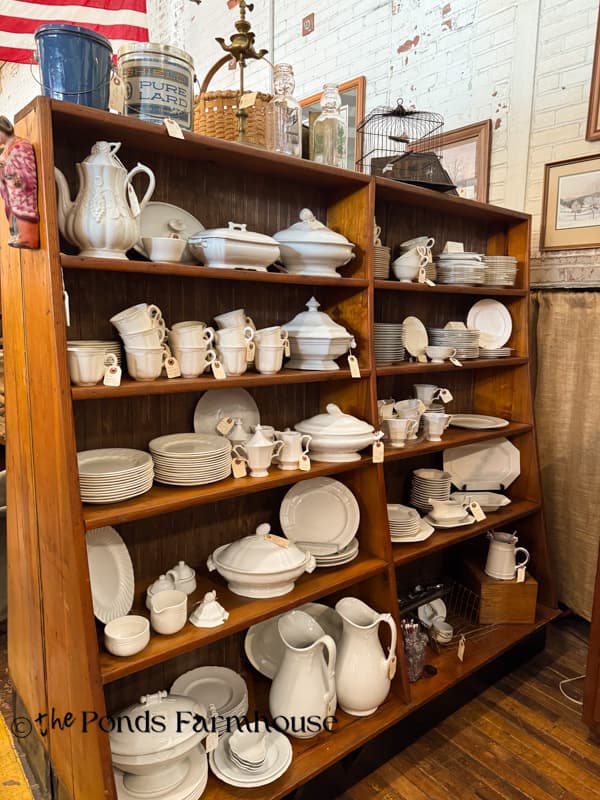 ironstone on a shelf in antique booth