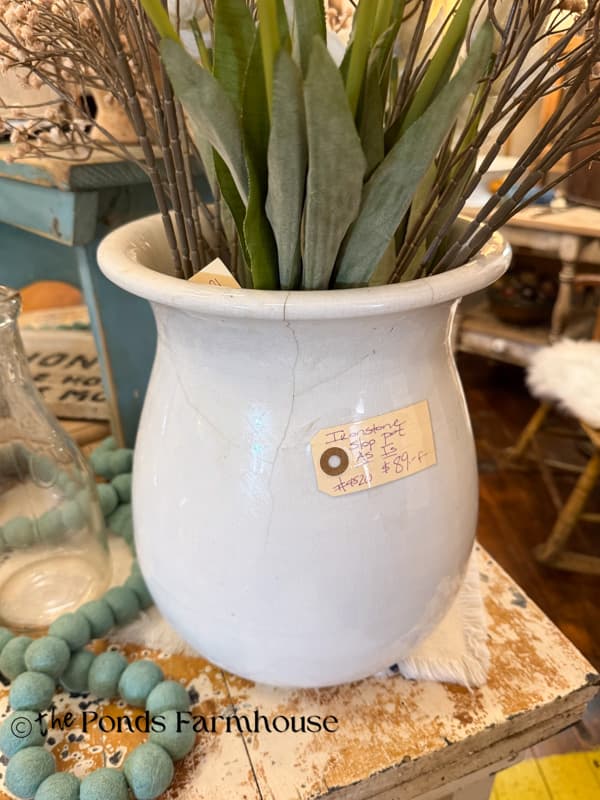 ironstone vase with crack in beautifully displayed antique booth