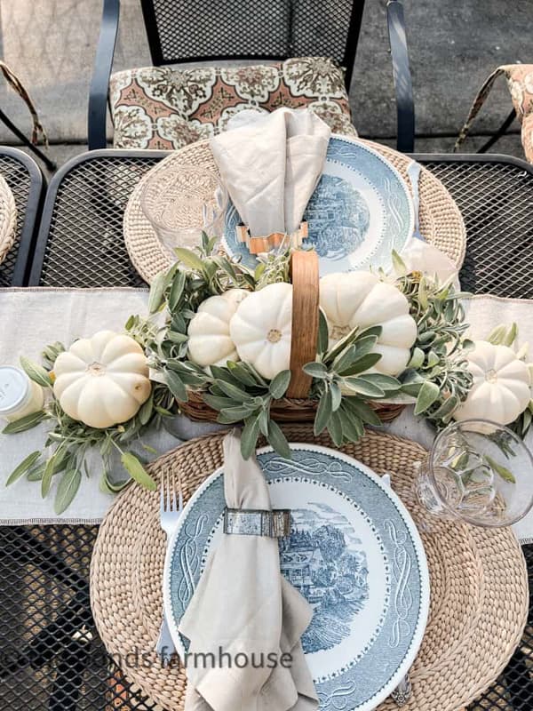 outdoor table with pumpkin and herb backet centerpiece