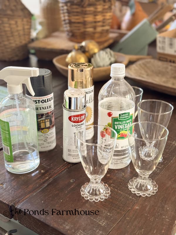supplies to upcycle thrift store glasses with a faux mercury glass finish.