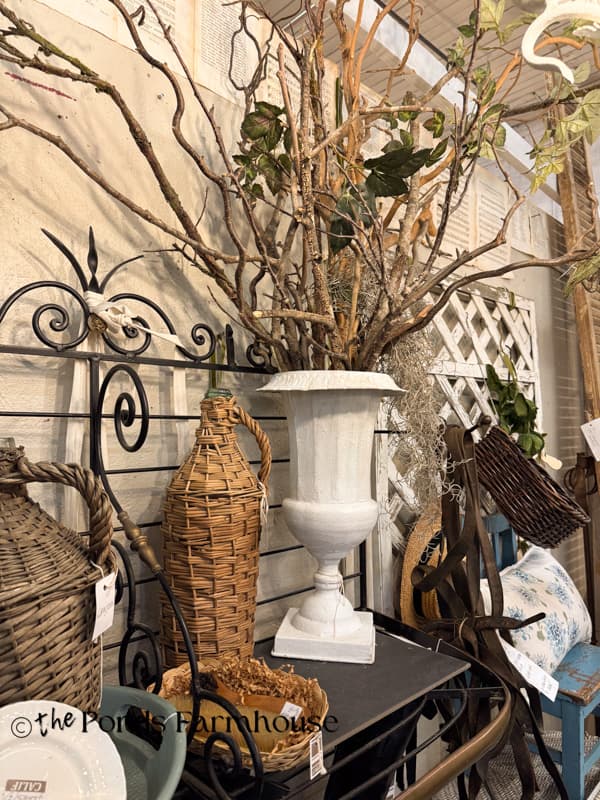 twig display and demi-johns in curated antique booth