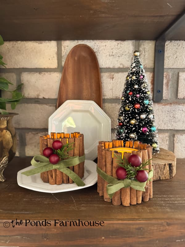 cinnamon stick tea light candle holder with upcycled tin cans on open shelving