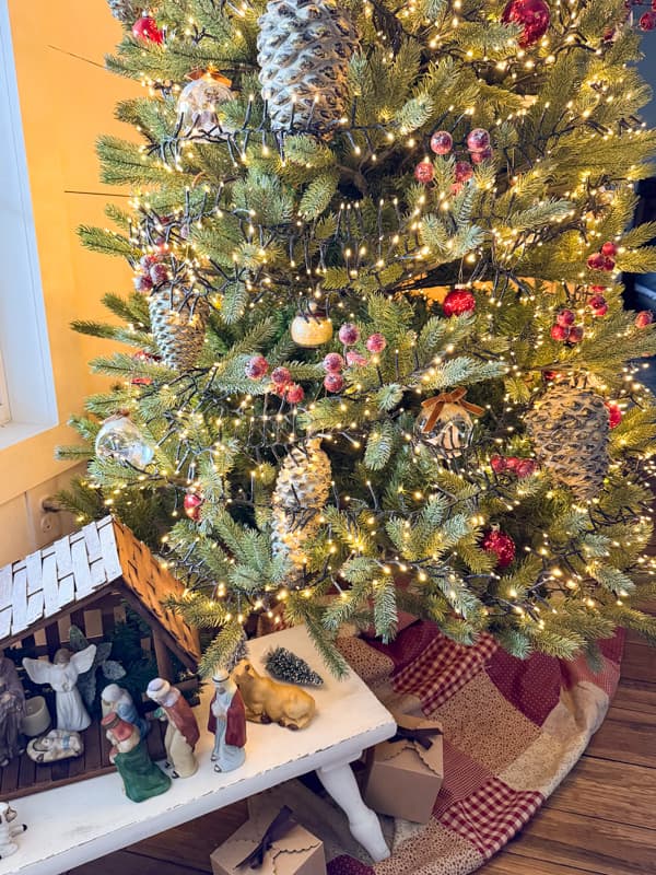 King of Christmas tree with DIY Quilted Skirt and Nativity Scene at base