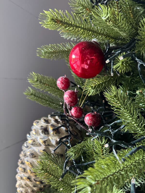 Tree with pinecone and berries and shiny brite red ornaments