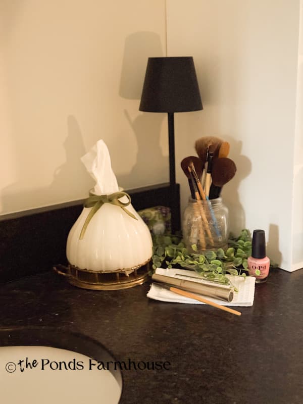 Vintage Milk glass lampshade on brass try in bathroom for tissue holder