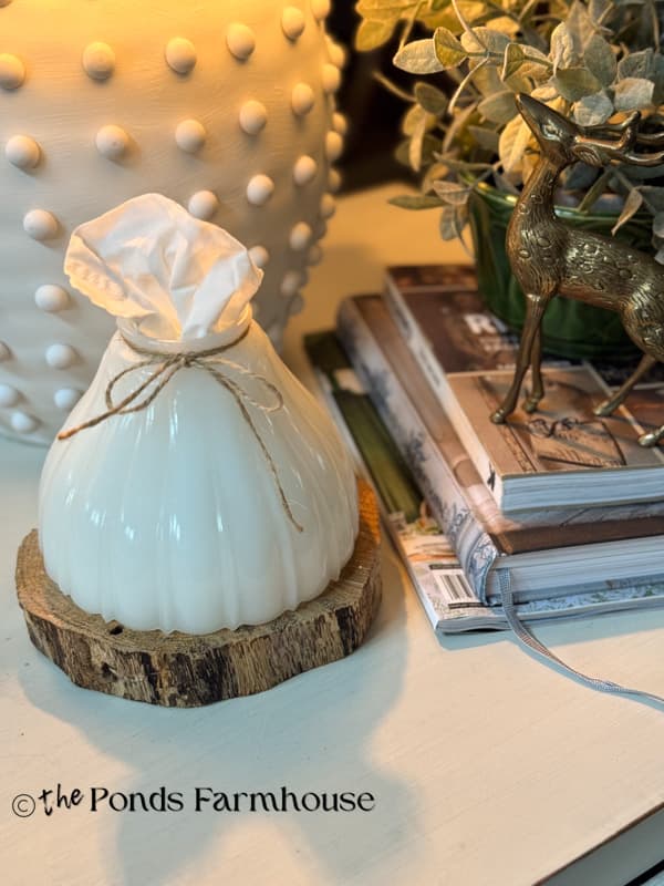 Vintage milk glass lampshade on wood slice for upcycled tissue holder