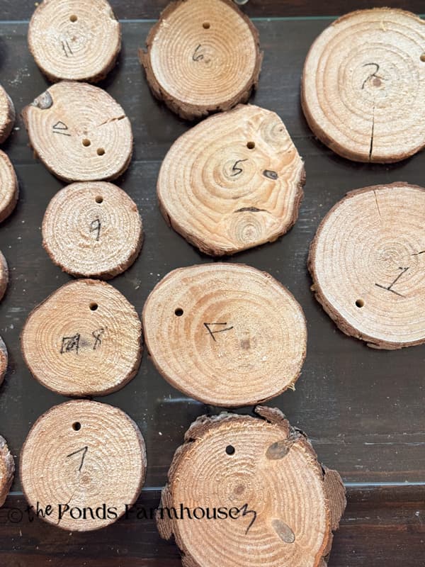 numbered wood slices with drilled holes for Christmas tree